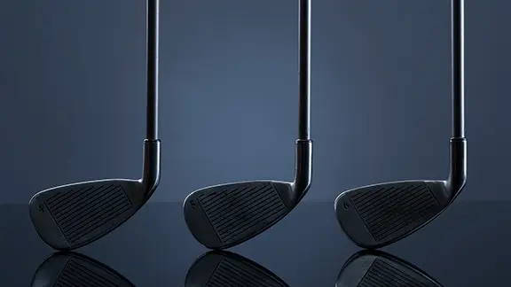 Three golf clubs in a horizontal row